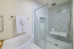 Primary Bathroom with soaker tub, rains shower, dual vanity, dressing area, and bay views